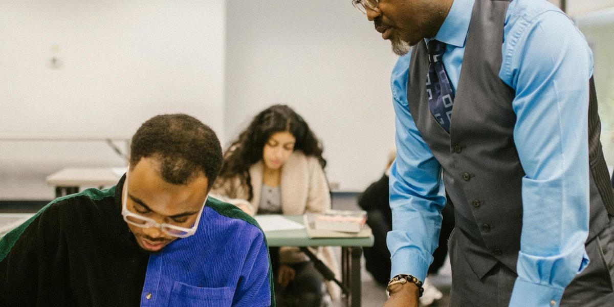 A teacher engaging in a one-on-one discussion with a student, providing constructive feedback.
