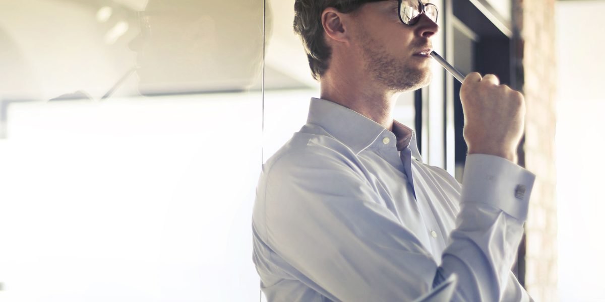 A business leader thoughtfully considering strategic options related to technology adoption.