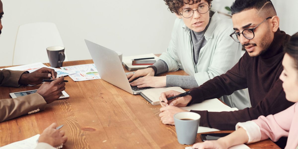 A team collaborating to select the most suitable AI tools for their business needs, discussing options.