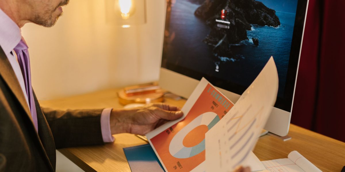 A professional analyzing charts and reports on a desk, representing the process of measuring ROI and evaluating performance of AI-generated content.