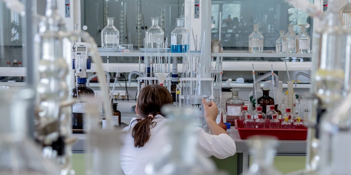 Scientists collaborate in a modern laboratory, depicting AI's role in accelerating research and discovery.