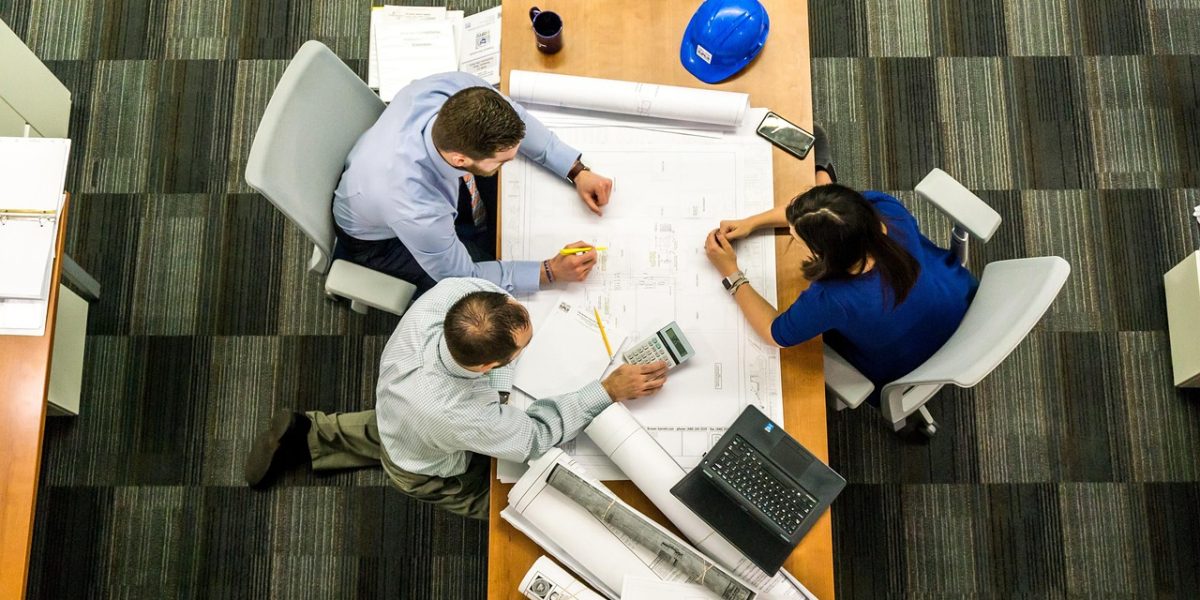 Professionals in a business meeting, deliberating strategies for monetizing AI technologies.