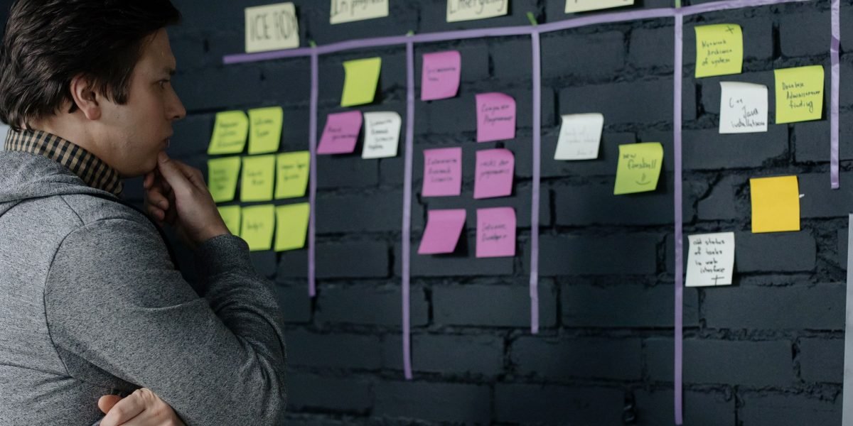 A person focused, brainstorming ideas to overcome writer's block, symbolizing the struggle and breakthrough in creative work.