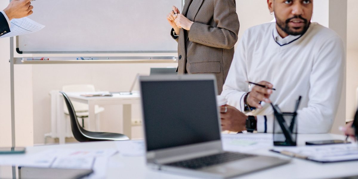A group of business professionals in a meeting, engaged in strategic discussion about industry trends.