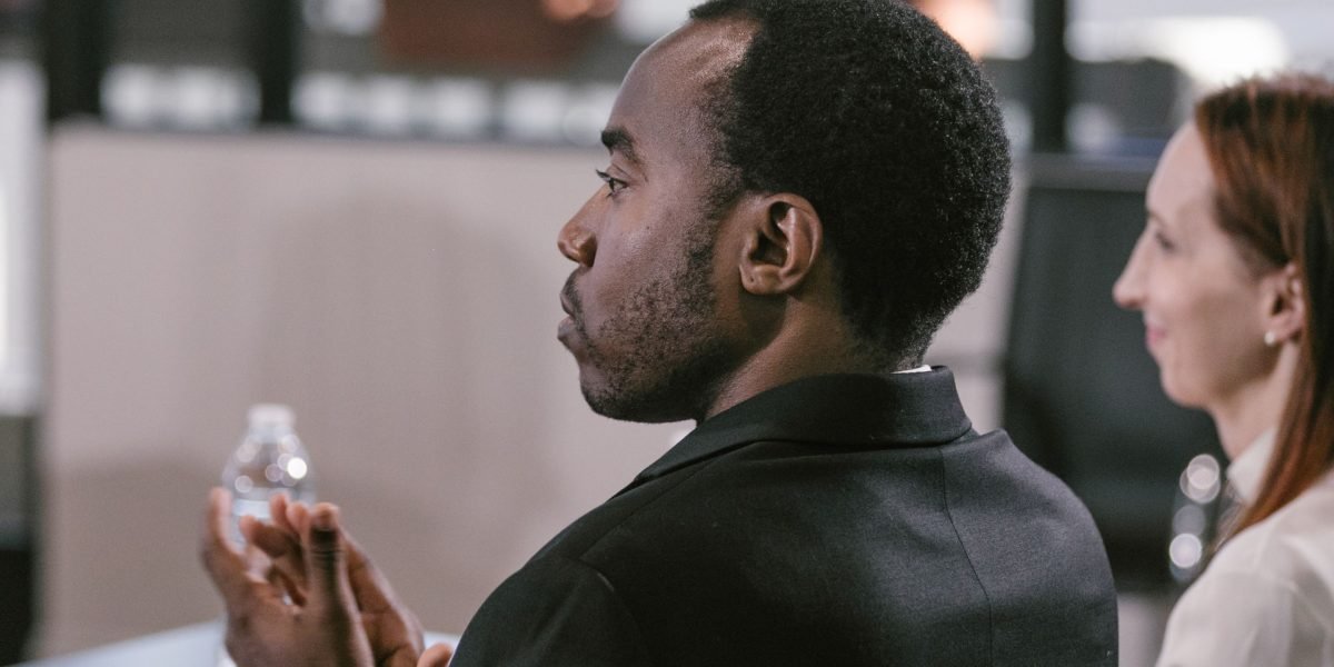 A professional actively asks questions, embodying the importance of critical evaluation in understanding AI fundamentals.