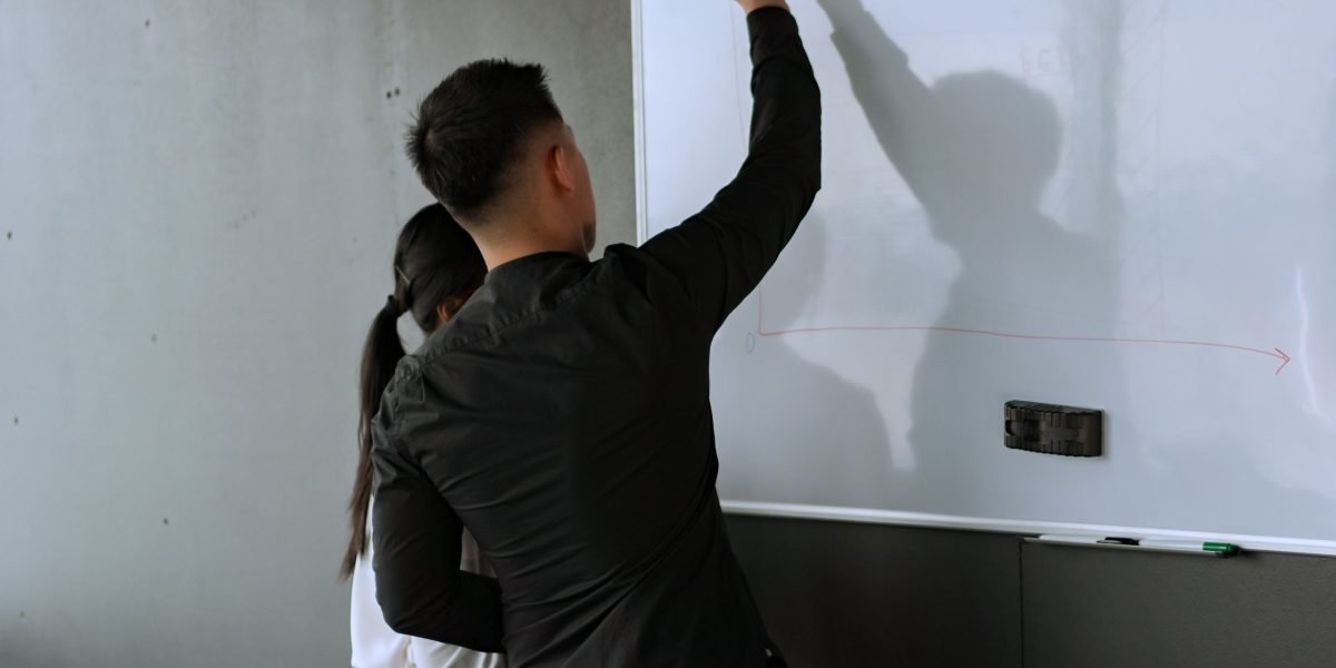 A team collaborating around a whiteboard, actively working to solve complex integration challenges for an enterprise AI project.