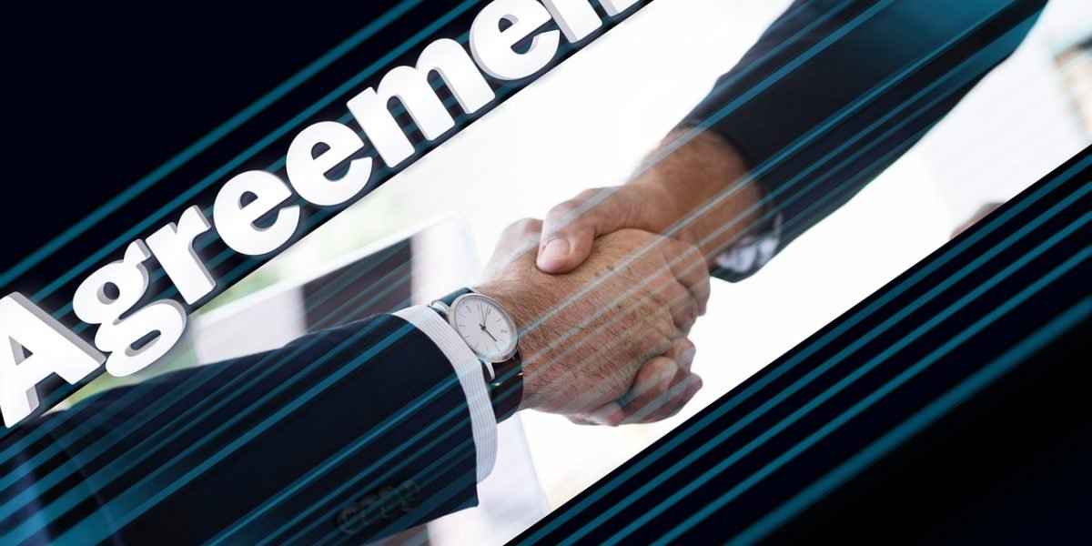 Two business professionals shaking hands or collaborating, symbolizing a positive and aligned partnership between a founder and an investor.