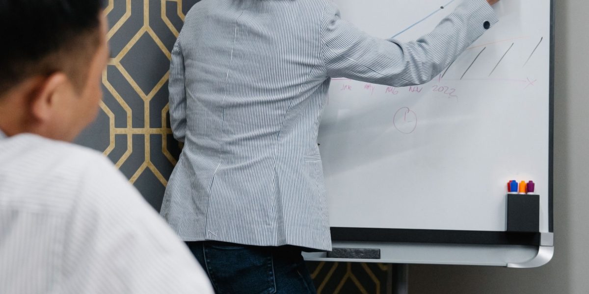 Founders actively collaborating, brainstorming ideas on a whiteboard, embodying the spirit of innovation and partnership.