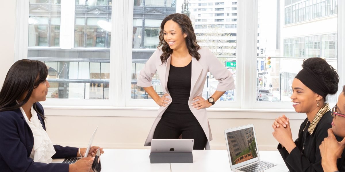 A confident business leader presenting insights and results from AI implementation to a team.