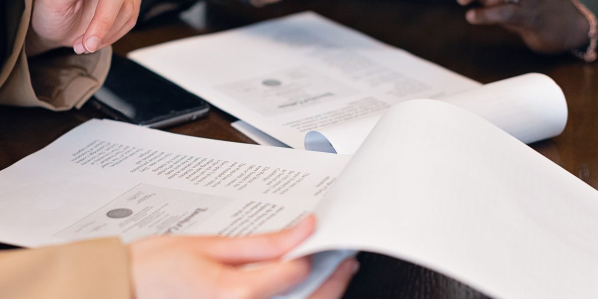 Business professionals in a meeting reviewing compliance-related documents.