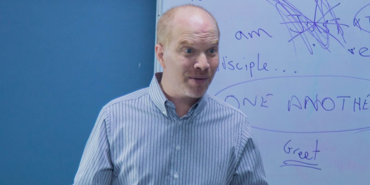 Someone explaining a complex concept, representing the underlying mechanisms of AI.