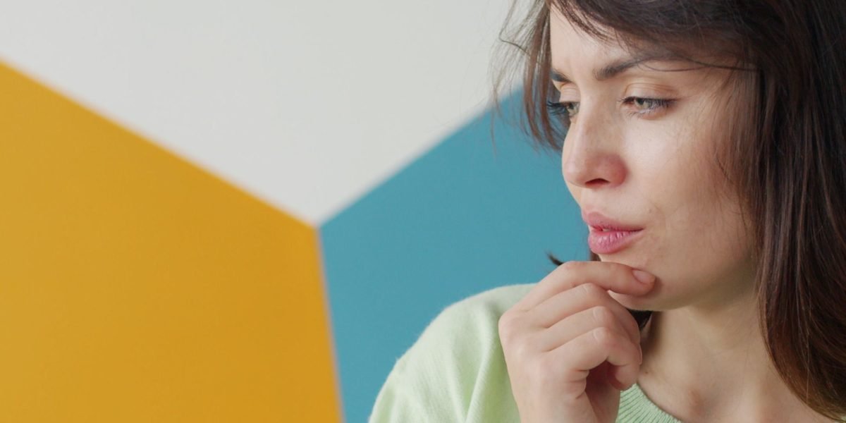 A person thoughtfully considering options, symbolizing the process of choosing the right AI summarizer.