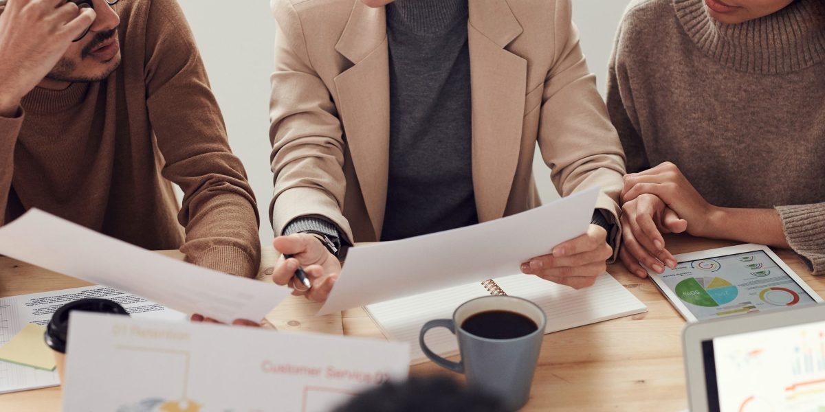 Researchers engage in collaborative discussion, representing the peer review and knowledge-sharing process in academic publishing.