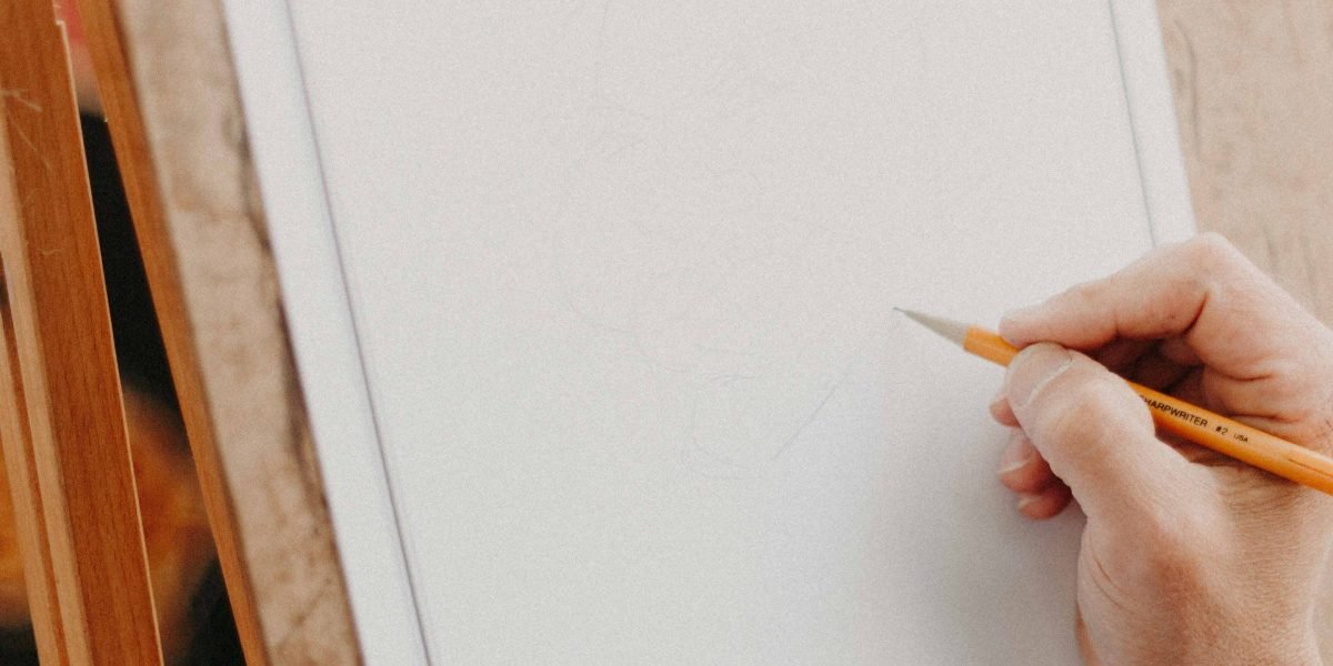 A creative professional engaged in the process of designing visual content, potentially using digital tools.