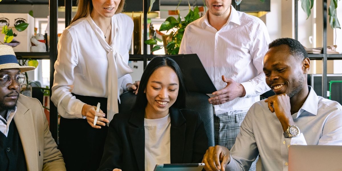 A team actively collaborating in a meeting setting, demonstrating improved productivity through shared tools and ideas.