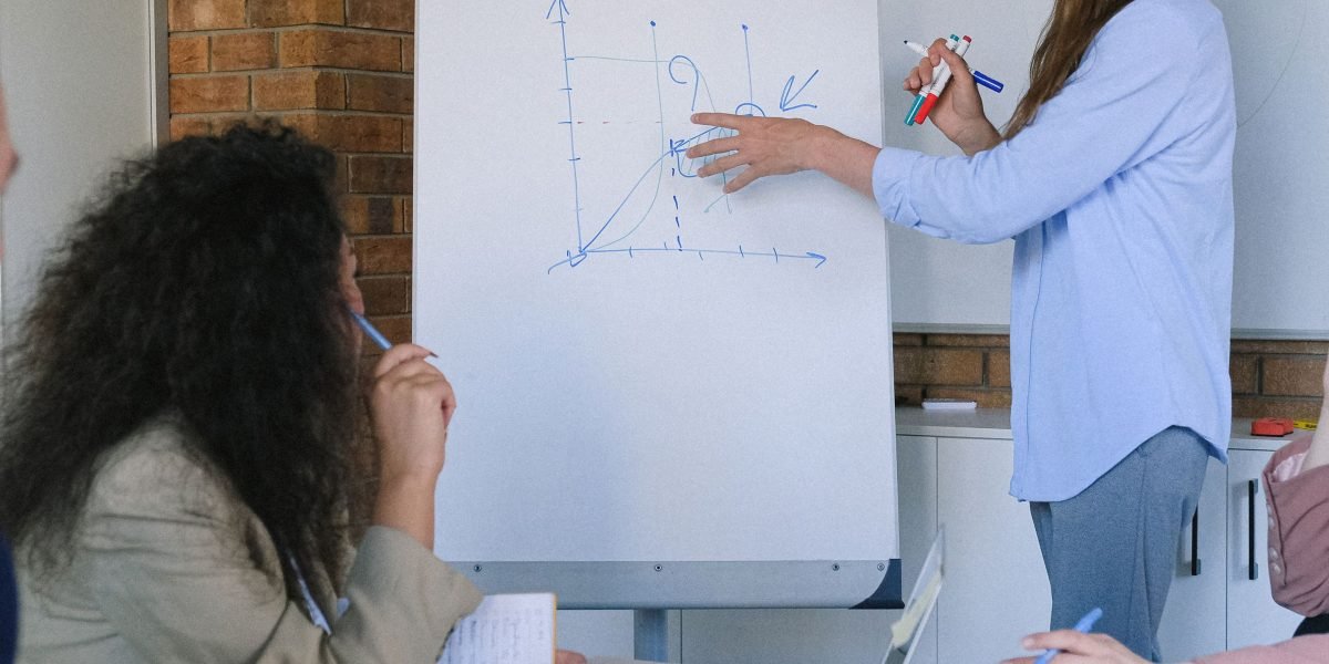 A team collaborating around a whiteboard, visually representing the complex challenge of measuring AI fairness.