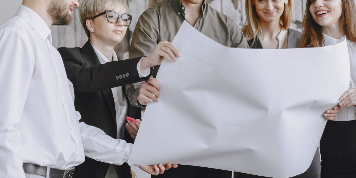 A diverse team collaborating in a modern office, symbolizing the collective effort behind building complex AI systems.