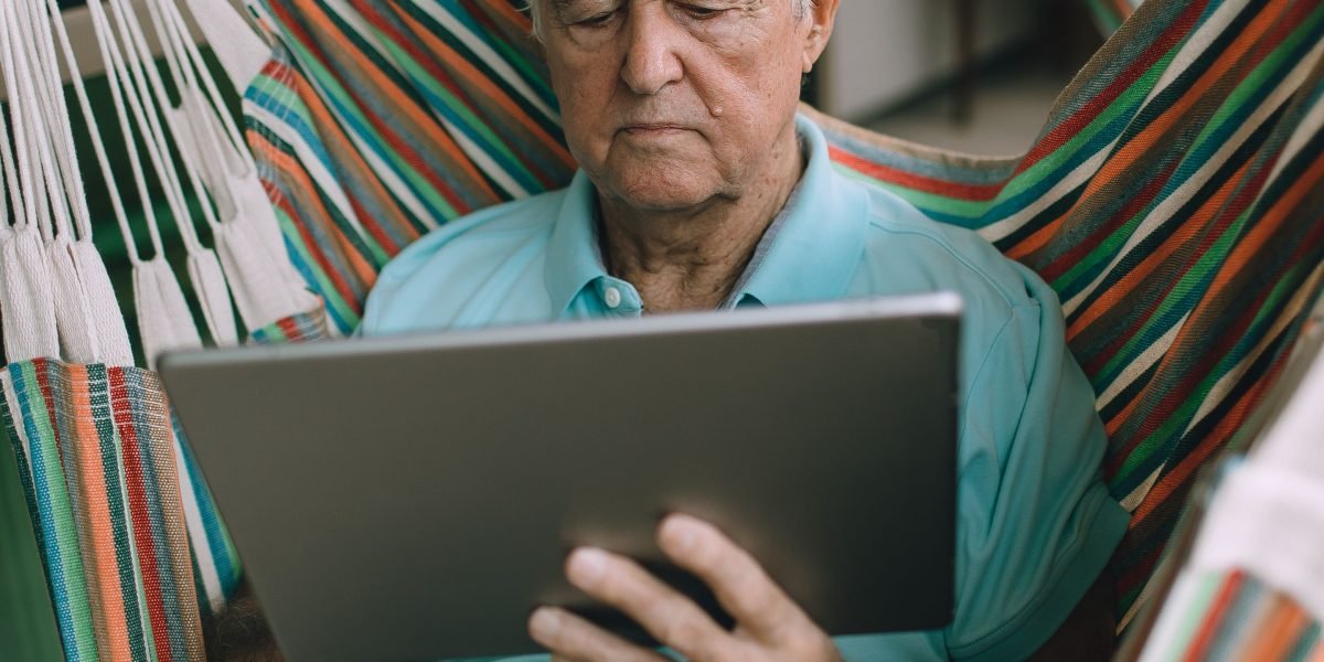 A person focused on reading the latest technology news, reflecting the importance of staying informed.
