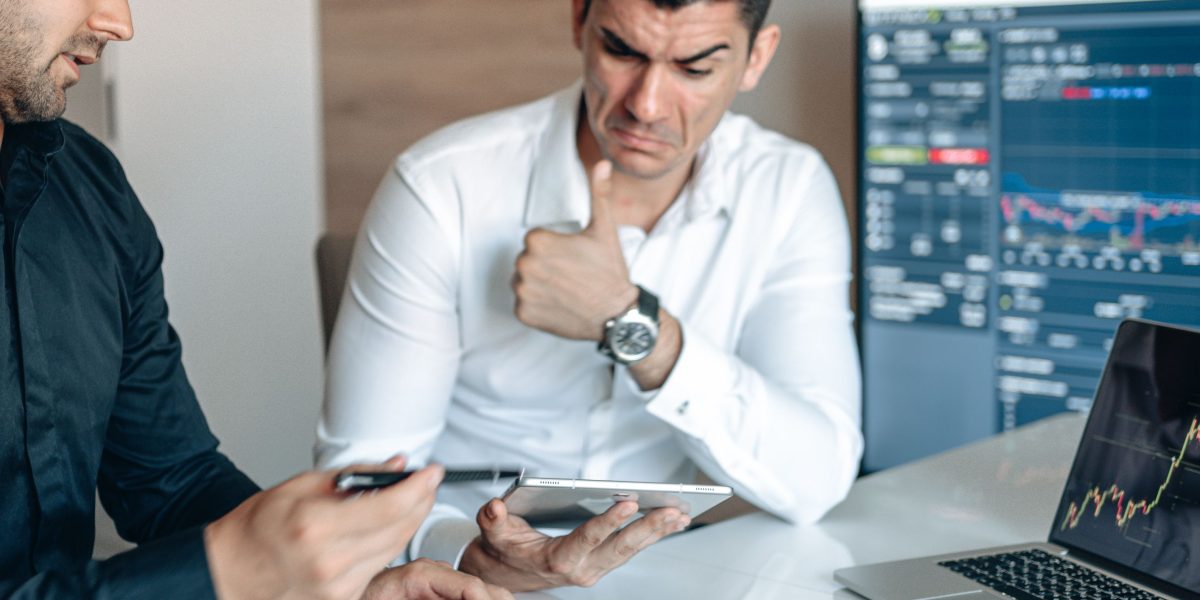 Business professionals reviewing charts, symbolizing market analysis and investment decisions.