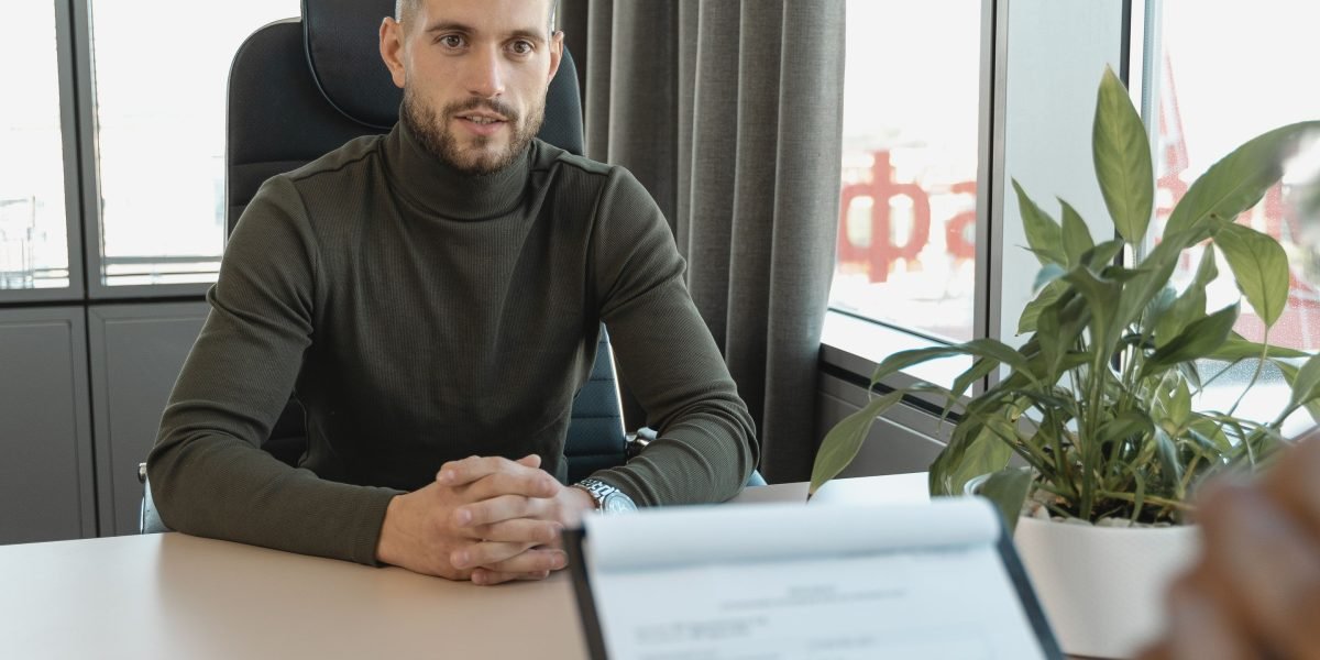 An interviewer and candidate in a meeting, representing the focus on hiring new talent in AI.