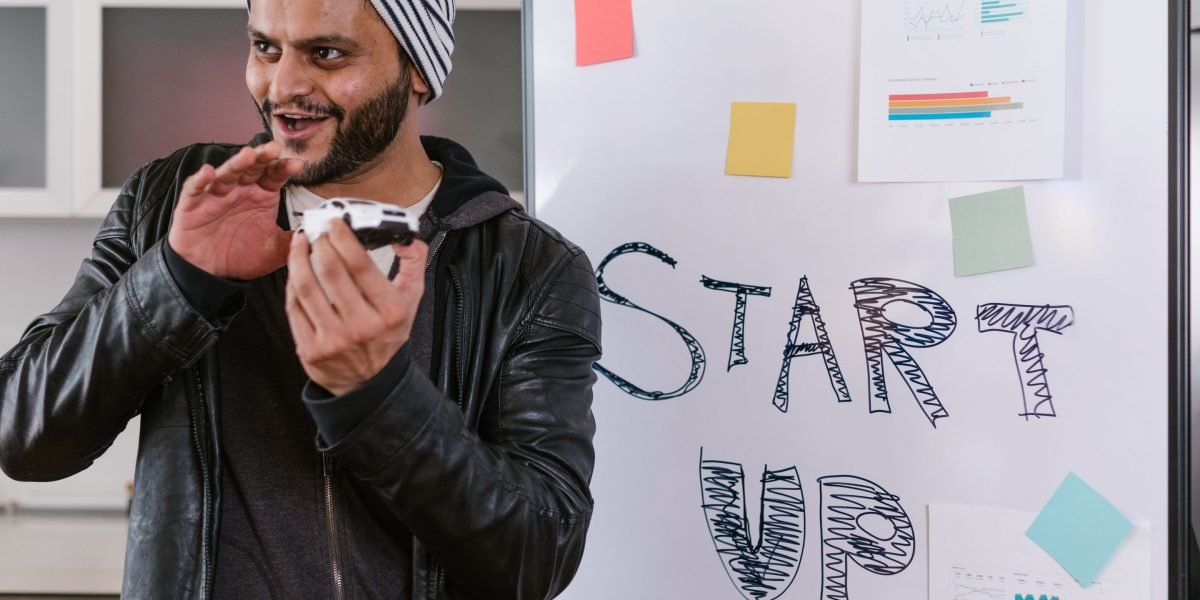 A founder confidently presents their business idea to potential investors, symbolizing the search for funding.