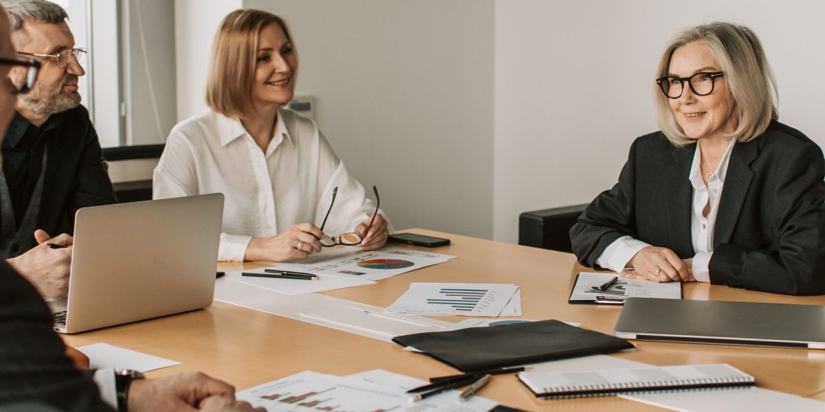 An executive team collaborates, discussing strategic plans to foster company growth and success.