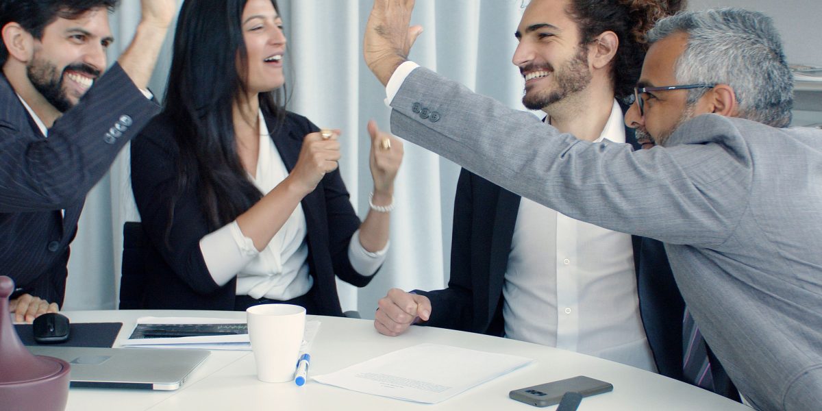 A diverse team celebrates a significant project success, reflecting the achievement of growth objectives.