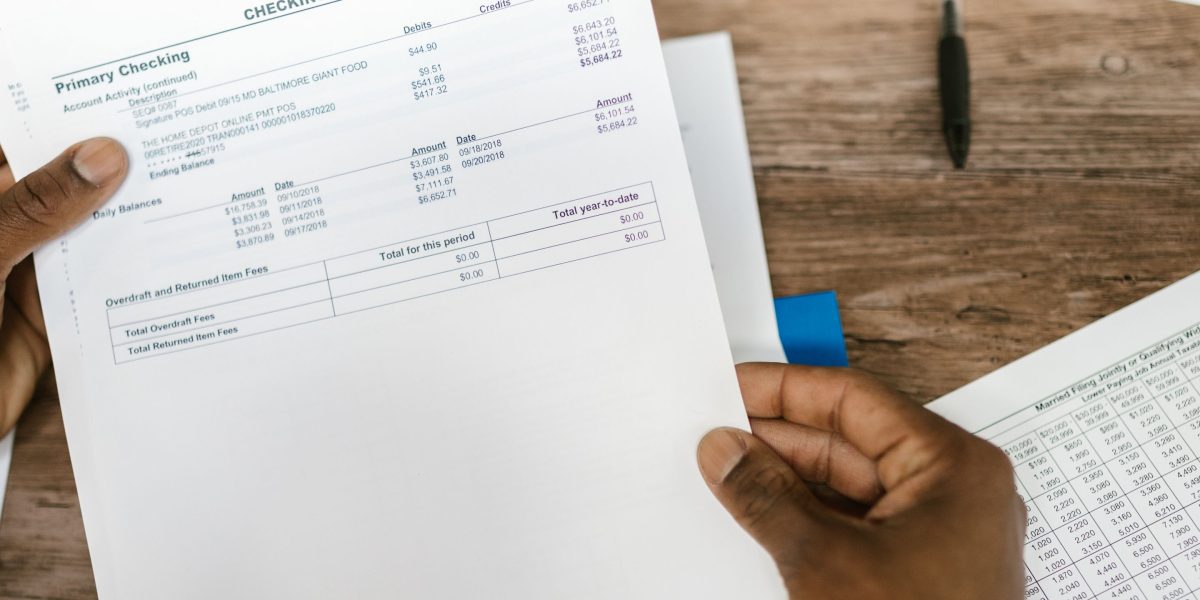 A person confidently reviewing detailed financial reports, representing the critical assessment of a private equity firm's track record.