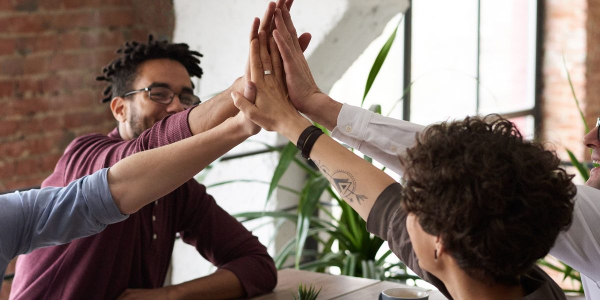A startup team celebrating a successful project milestone, showing the positive outcome of effective tool usage.