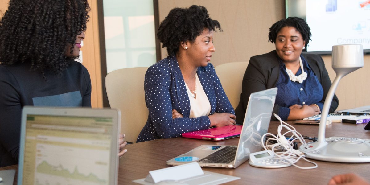 Business professionals engage in a serious discussion about the future implications of advanced artificial intelligence.