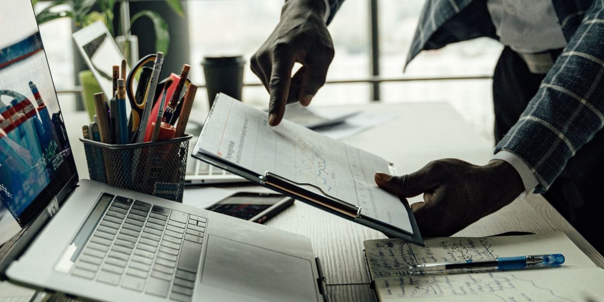 Business leaders review market reports and economic data, analyzing AI's growing impact on various industries.