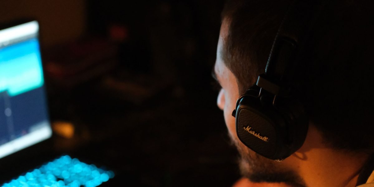 A person focused on audio production, symbolizing the creative use of AI voice technology.