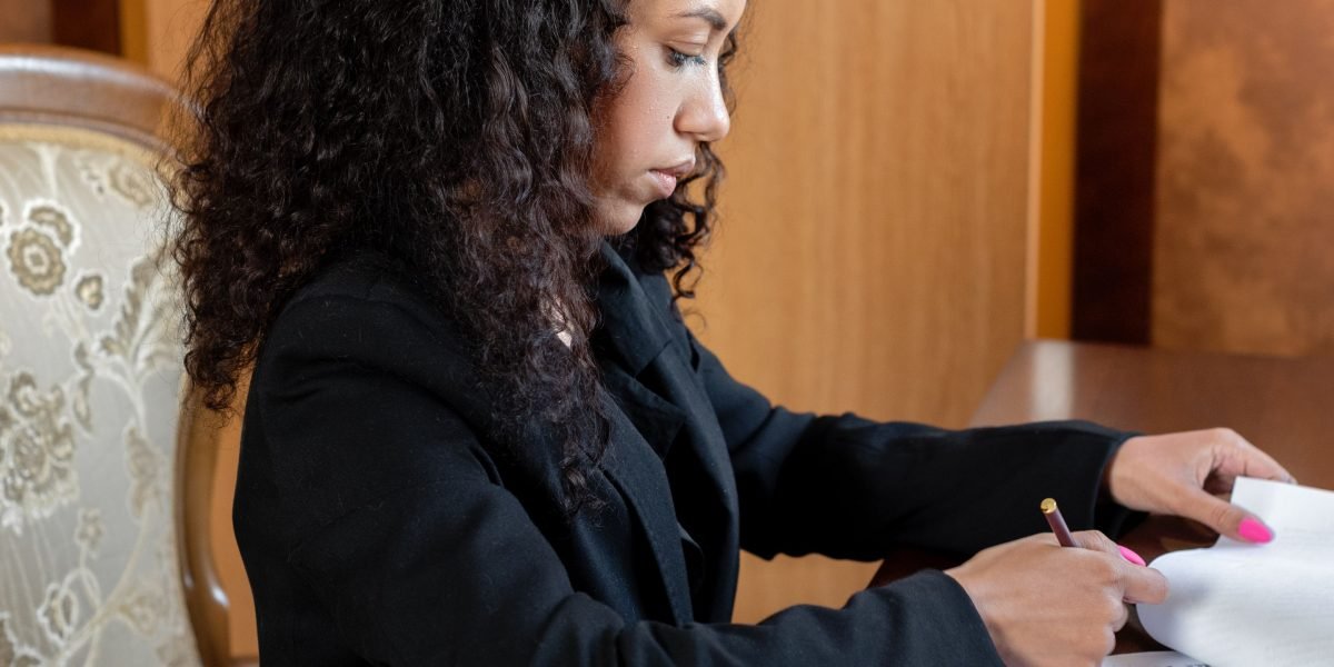 A person carefully reviewing legal documents, symbolizing the critical consideration of AI regulations and ethical guidelines.
