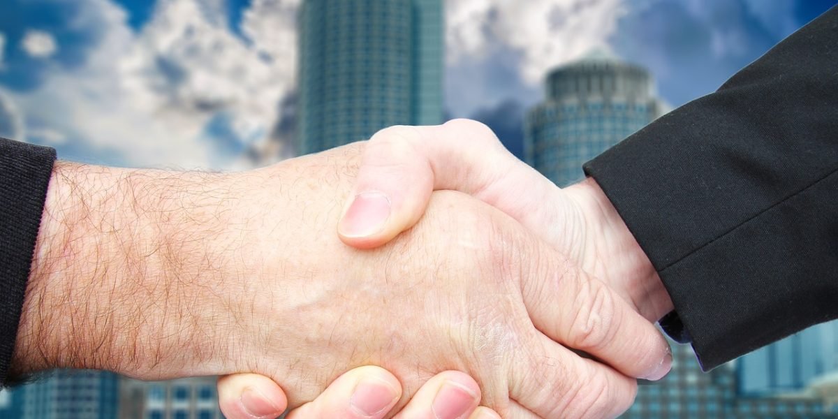 A confident handshake signifies a successful partnership or agreement in the business world.