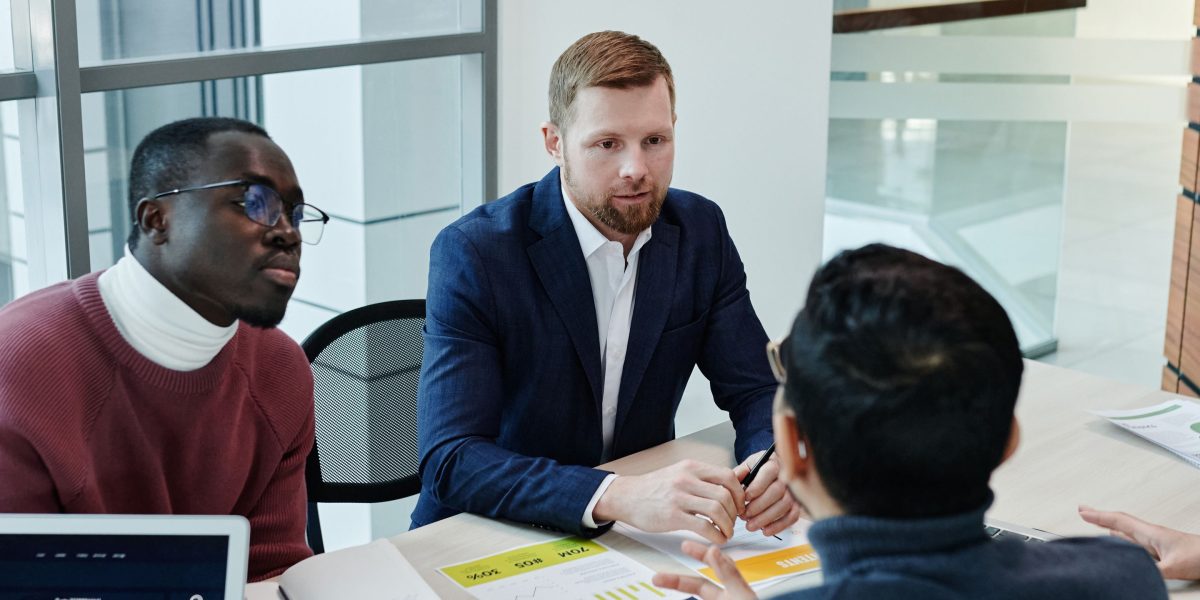 A team of professionals in a meeting, actively discussing and strategizing risk management practices.