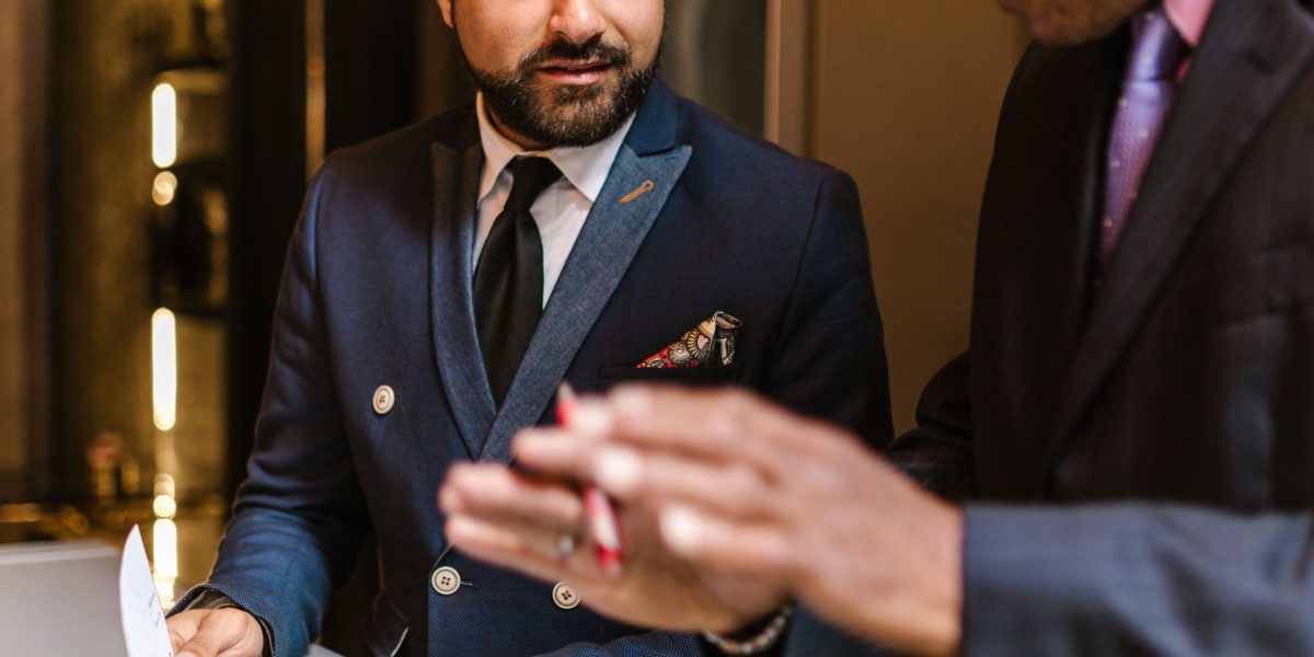 Depict business leaders carefully examining reports and data, signifying the due diligence process.